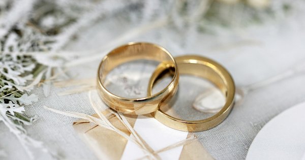 Two gold rings on a white background