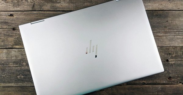 Closed laptop lying on a wooden background.