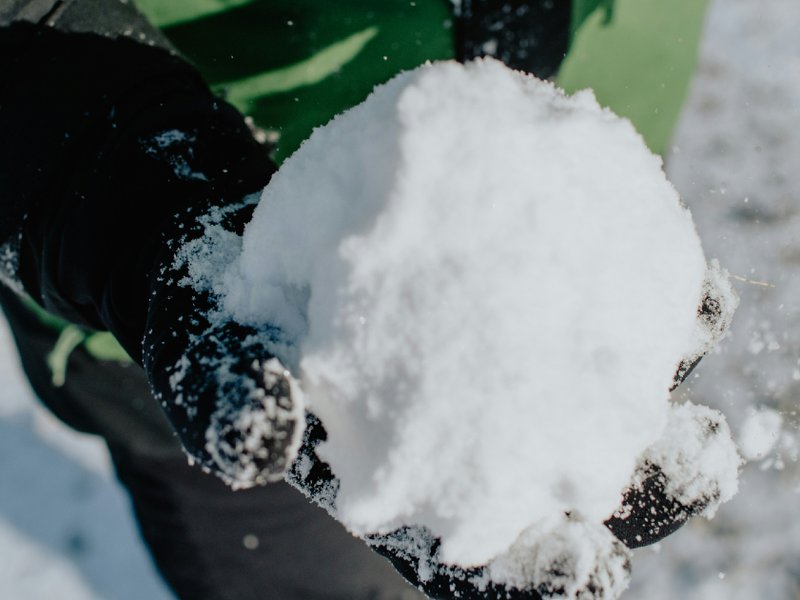 A picture of a person holding a snowball.