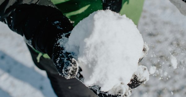 A picture of a person holding a snowball.
