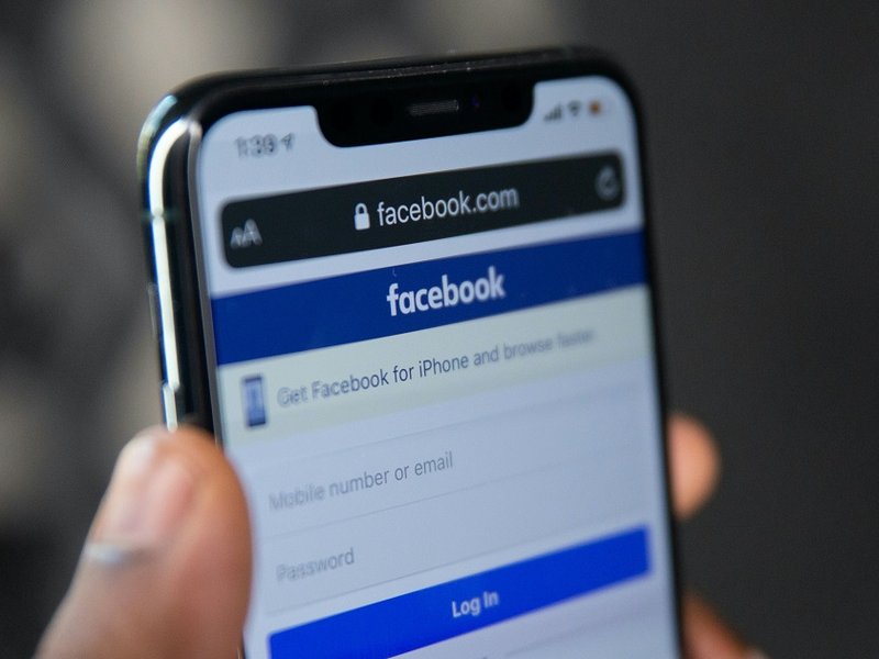 A mobile phone showing the Facebook log-in page