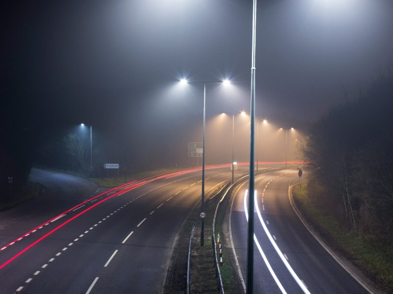 A road at night, lit by streetlights.