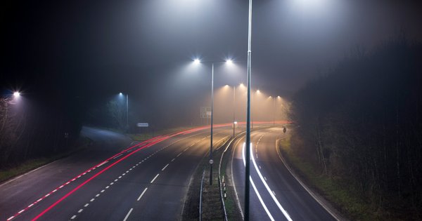 A road at night, lit by streetlights.