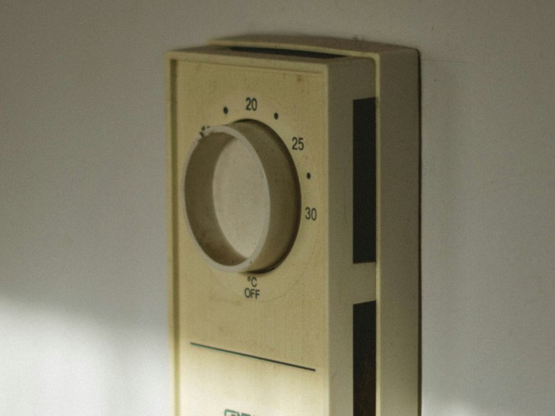 An image of a thermostat mounted on a wall