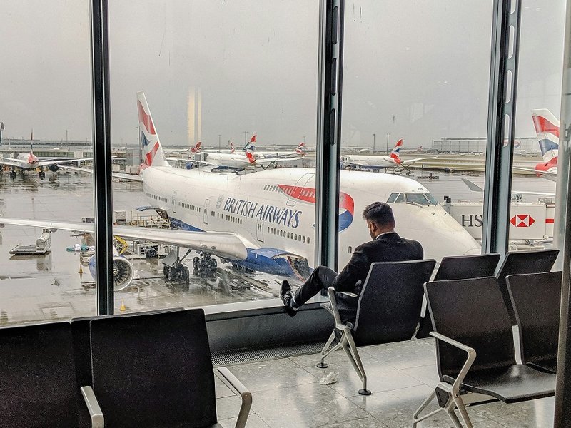 A man sitting in an airport departure hall