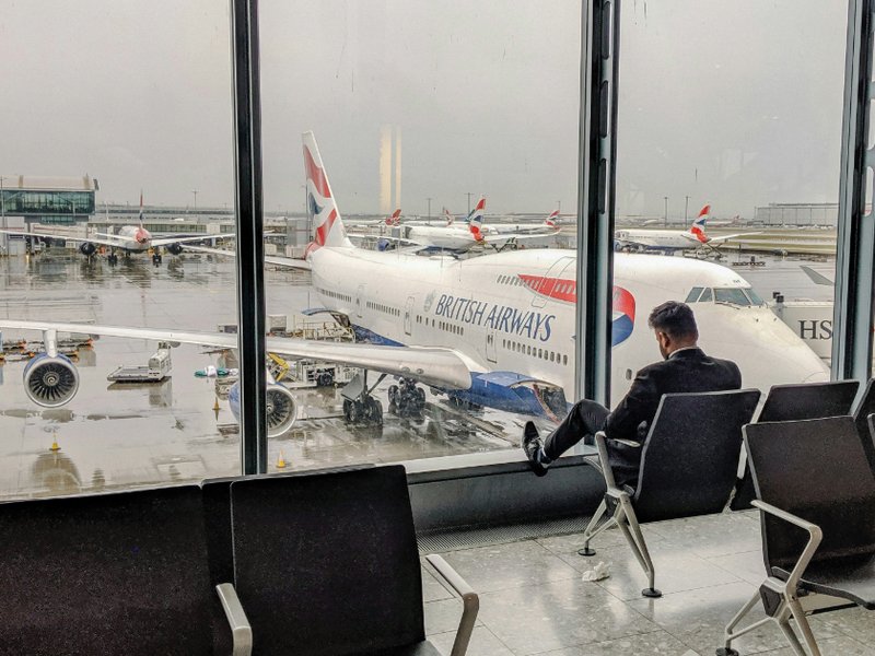 Man waiting for plane at Heathrow airport