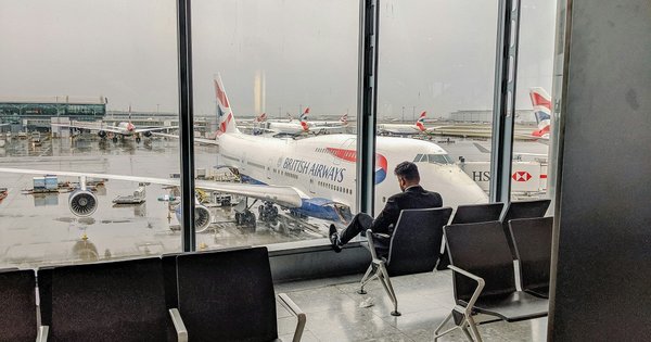 A man sitting in an airport departure hall