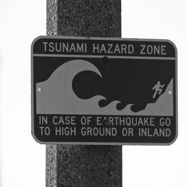 A tsunami hazard zone sign at a beach.