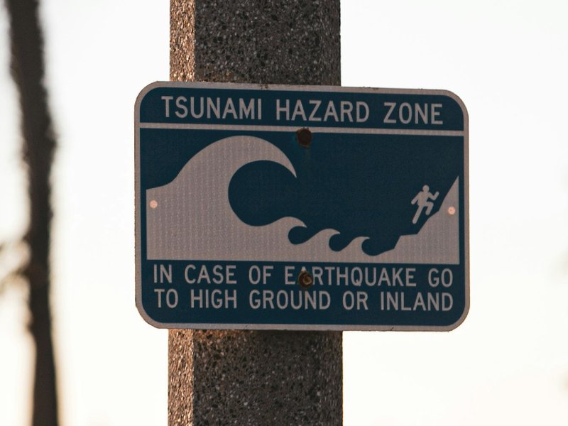 A tsunami hazard zone sign at a beach.